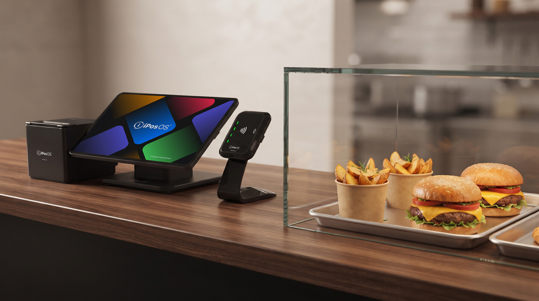 iPosOS POS terminal and card reader on a counter next to fresh burgers and fries